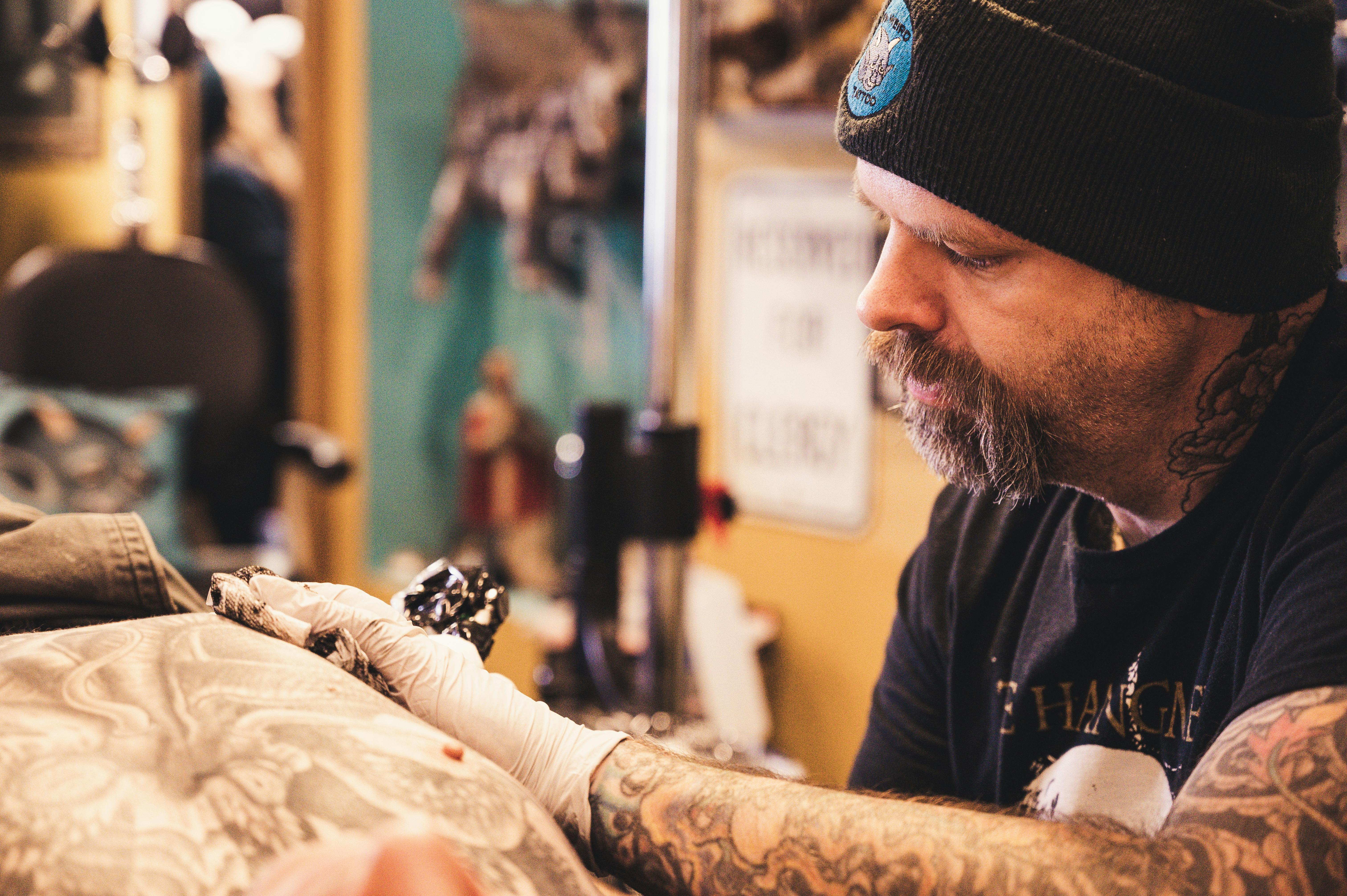 tattoo artist giving a tattoo